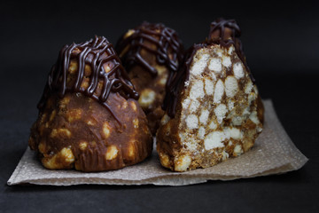 anthill cake with chocolate, closeup. on dark background