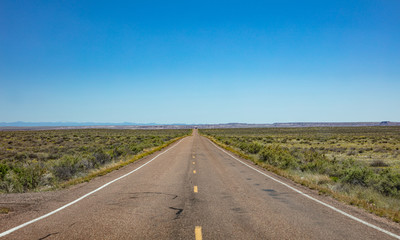 Long highway in the american desert, blue sky