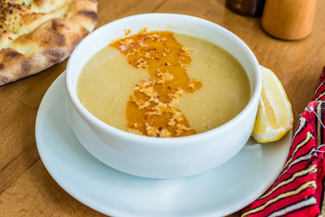 Turkish Lentil Soup with fried butter sauce / Mercimek Corbasi at Restaurant.