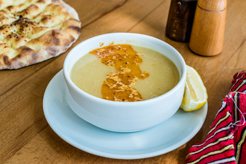 Turkish Lentil Soup with fried butter sauce / Mercimek Corbasi at Restaurant.