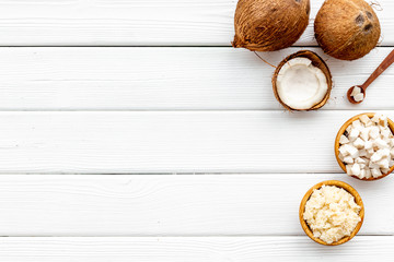 Fototapeta na wymiar natural coconut to make organic cosmetics on white wooden background top view copyspace