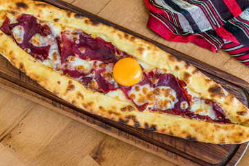 Traditional Turkish Pide at Kebab Restaurant on Wooden Table.