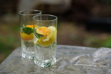 Summer lemonade with lemon, lime, ginger, with wildflowers on the table