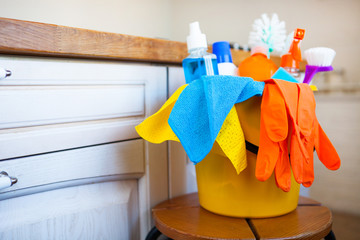 Basket with cleaning items on blurry background white citchen. Cleaning concept. - 279709574