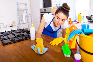 Beautiful young woman makes cleaning the house. Girl cleaning kitchen. Set.
