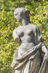 Old statue of a sensual Renaissance era woman in park of Potsdam, Germany, details, closeup