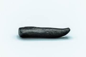 Black magnetic Tektite Meteorite isolated, piece of rock formed in big meteorite collision at...