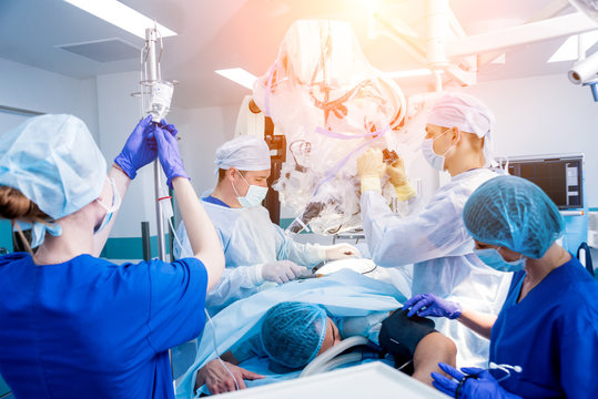 Spinal Surgery. Group Of Surgeons In Operating Room With Surgery Equipment. Laminectomy