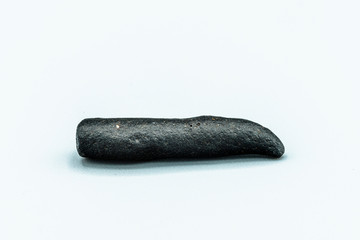 Black magnetic Tektite Meteorite isolated, piece of rock formed in big meteorite collision at...