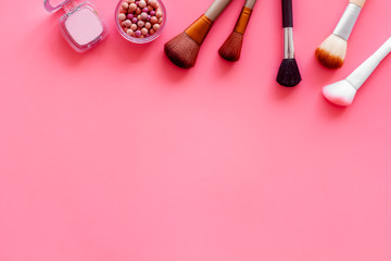 Instruments for make up with brushes, blusher on pink background top view mock up