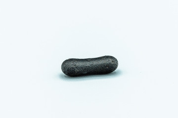 Black magnetic Tektite Meteorite isolated, piece of rock formed in big meteorite collision at...
