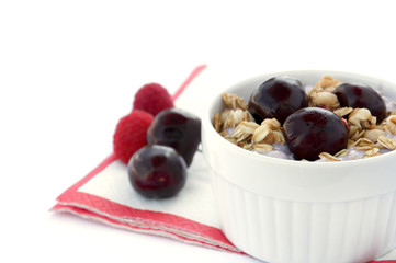 Healthy Breakfast with Cereals, Yogurt, Cherries and Raspberries in White Bowl