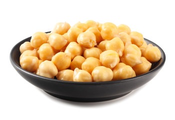 chickpeas in black bowl isolated on white background