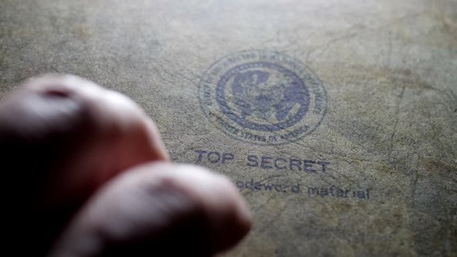Fingers tapping on top secret document