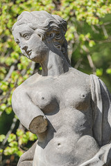 Old statue of a sensual Renaissance era woman in park of Potsdam, Germany, details, closeup