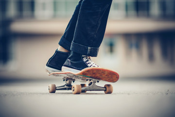 Skateboard man practices to ride on asphalt, learns tricks