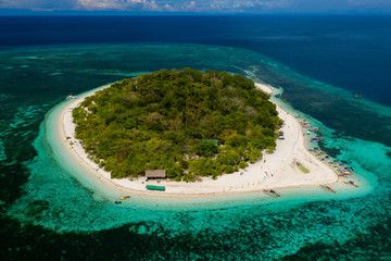 Aerial view of a beautiful tropical island surrounded by coral reef (Mantigue Island, Camiguin, Philippines)