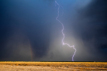 Thunderstorm lightning bolt with dark sky and rain