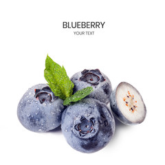 Blueberries composition with mint leaf and water drops. Cut in half fruit. Food concept with copy space. Isolated on white