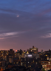 Aerial view of Downtown manhattan with crescent moon at night