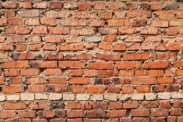 textured, expressive wall of red bricks