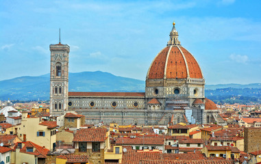 Fototapeta na wymiar Aerial view of Duomo Florence Cathedral and buildings in the old city. The medieval Cathedral with iconic red dome is the third largest church in the world. Panoramic skyline. Italy, Florence