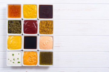Set of different sauces in ceramic bowl