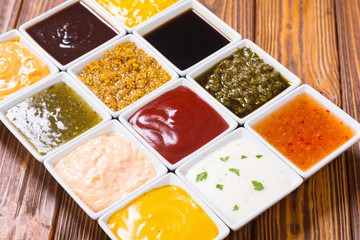 Set of different sauces in ceramic bowl