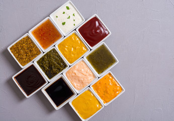 Set of different sauces in ceramic bowl