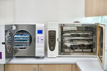 Sterilize machines with opened doors and dental tools inside
