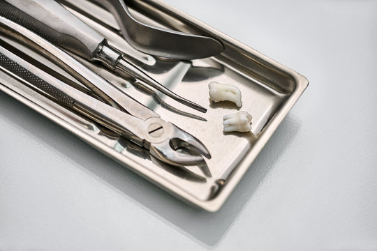 Dental Instruments Lying In Chrome Medical Tray