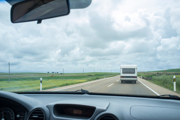 Driving slowly behind a caravan by country road