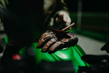 Brown leather biker gloves for motorcyclist, outfit.