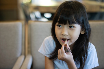 Asian child cute girl Eat pork steak