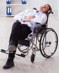 Obraz premium Doctor resting on wheelchair in hospital after night shift