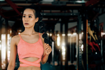 sport woman at fitness gym club doing exercise for arms with kettlebell and showing muscle bodybuilding, fitness concept, sport concept