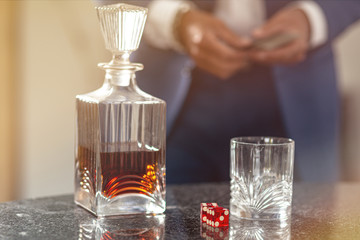 Alcohol use is life abuse. Alcohol and dice on the table
