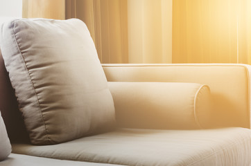 Fabric cushiion brown sofa with pillows in living room, close up
