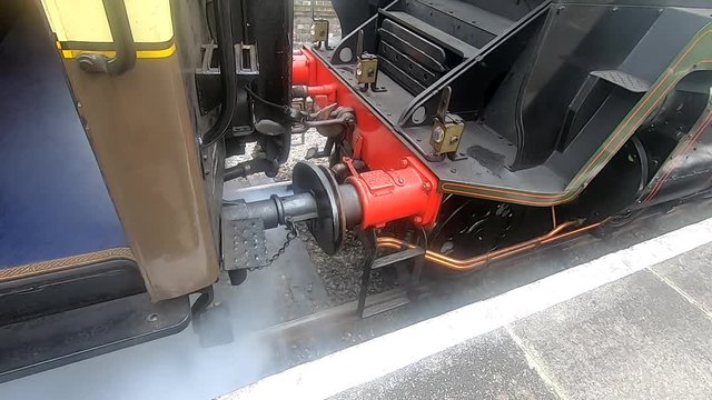 Front of steam loco expelling steam under high pressure