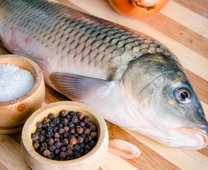 Uncooked fish on cutting board in meal preparation concept