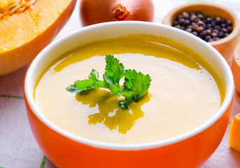 Pumpkin soup served on the table in bowl