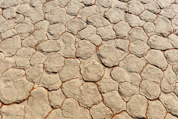 Cracked clay soil with a texture of yellow red blocks with red veins. Africa. Namib Desert .
