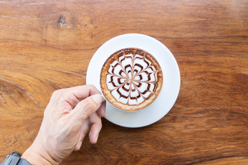 Coffee cup with latte art foam on wood table in coffee shop with copy space.Coffee is one of the most popular beverages.Improve Energy Levels and Burn Fat