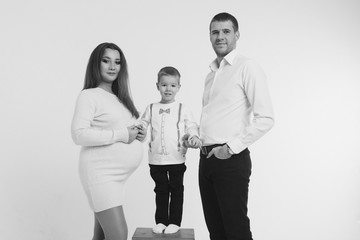 family photo on a white background: parents spend time with their children. mom and dad hug the baby. the concept of childhood, fatherhood, motherhood, IVF