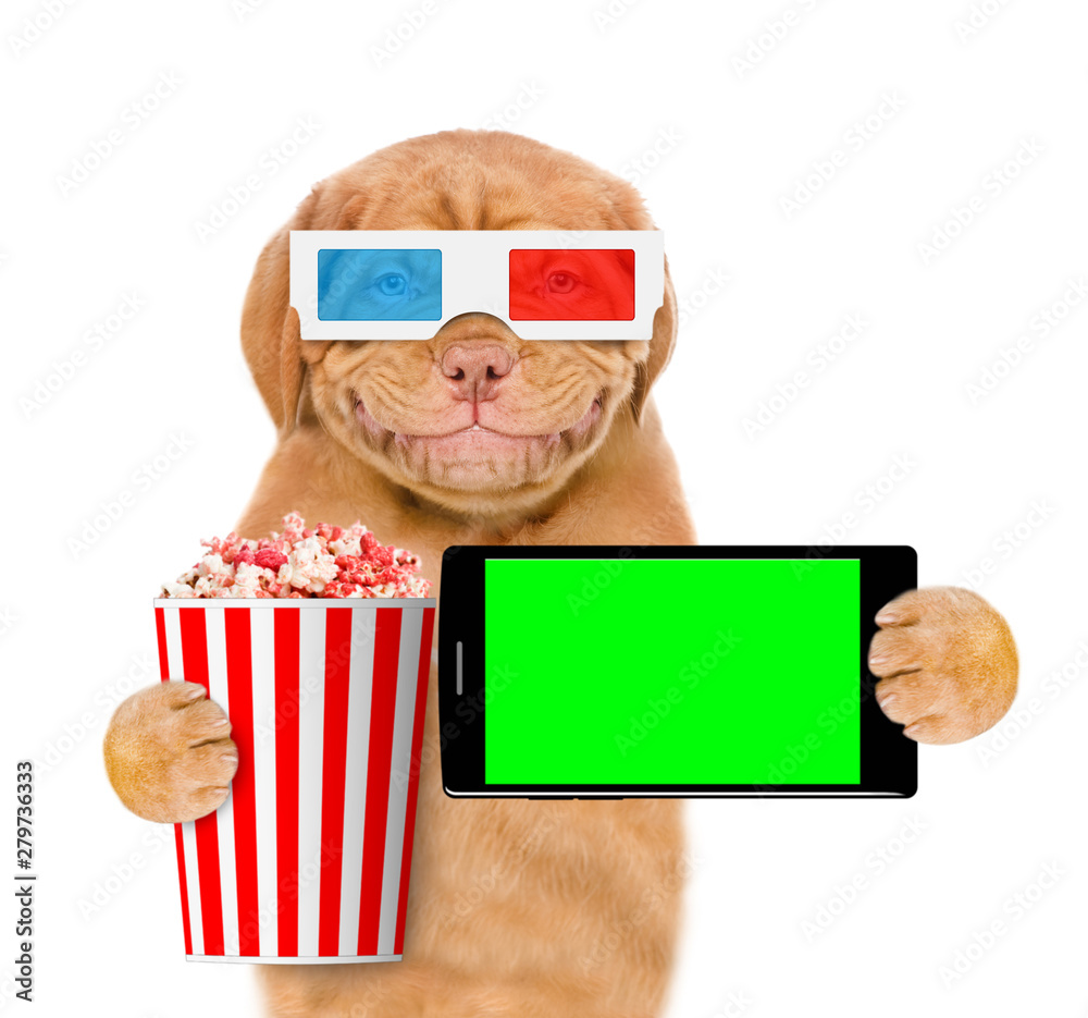 Poster smiling puppy in 3d glasses holding popcorn basket and smartphone. isolated on white background