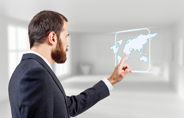 Businessman touches glowing world map icon.