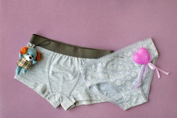 Panties for boys and girls. Gray panties for children on a purple background. Underwear from soft...