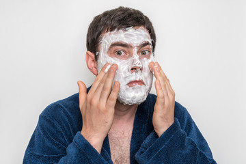 Funny man with natural white cream mask on his face