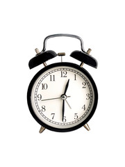 Vintage black alarm clock on a white background