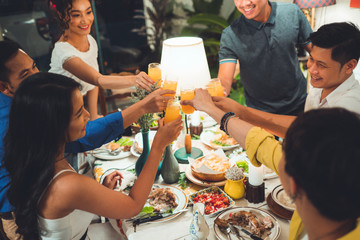 Asian people are eating dinner At home with friends they're happy